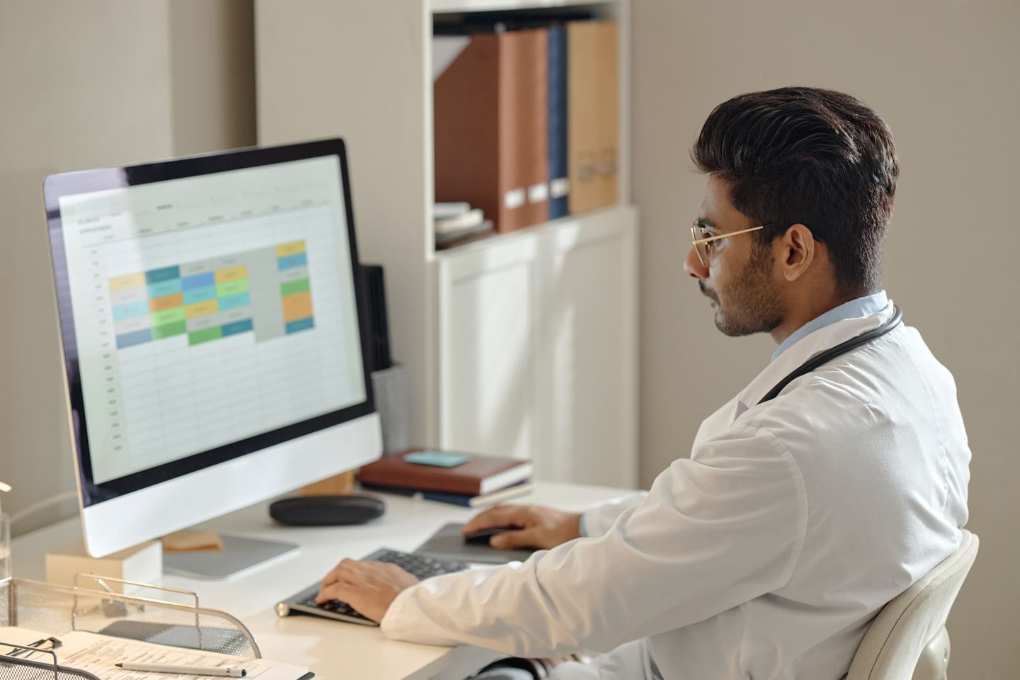 Healthcare professional reviewing records on a tablet